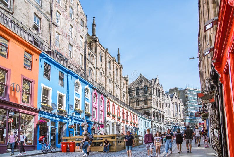 Scotland, Edinburg - August 24, 2022: Victoria street with beautiful curve and colourful shopfronts, built in 1860th and designed in the fashionable Scots Baronial style. Scotland, Edinburg - August 24, 2022: Victoria street with beautiful curve and colourful shopfronts, built in 1860th and designed in the fashionable Scots Baronial style.