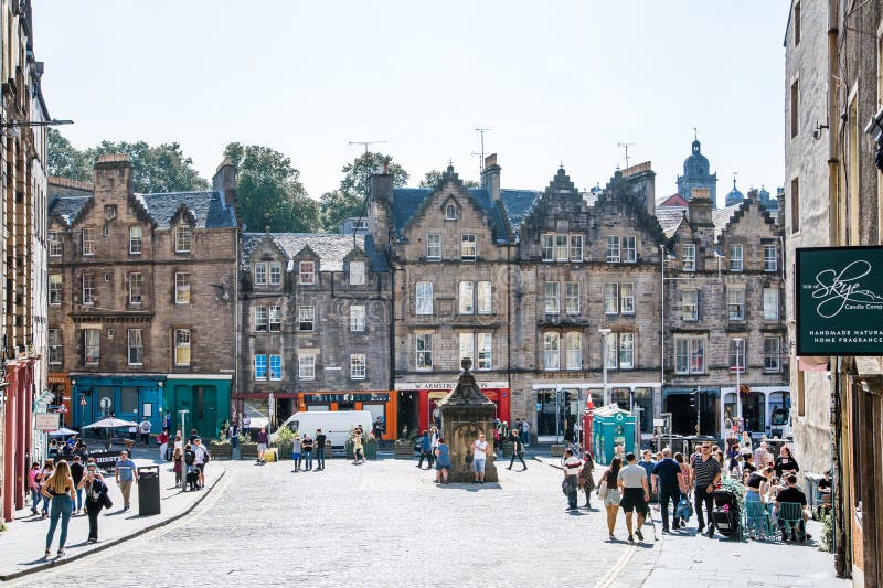 Scotland, Edinburg - August 24, 2022: Victoria street with beautiful curve and colourful shopfronts, built in 1860th and designed in the fashionable Scots Baronial style. Scotland, Edinburg - August 24, 2022: Victoria street with beautiful curve and colourful shopfronts, built in 1860th and designed in the fashionable Scots Baronial style.