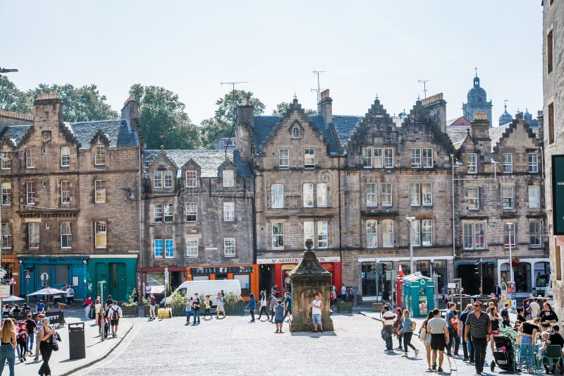 Scotland, Edinburg - August 24, 2022: Victoria street with beautiful curve and colourful shopfronts, built in 1860th and designed in the fashionable Scots Baronial style. Scotland, Edinburg - August 24, 2022: Victoria street with beautiful curve and colourful shopfronts, built in 1860th and designed in the fashionable Scots Baronial style.