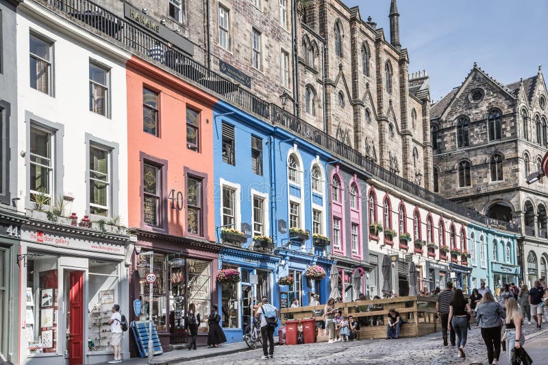 Scotland, Edinburg - August 24, 2022: Victoria street with beautiful curve and colourful shopfronts, built in 1860th and designed in the fashionable Scots Baronial style. Scotland, Edinburg - August 24, 2022: Victoria street with beautiful curve and colourful shopfronts, built in 1860th and designed in the fashionable Scots Baronial style.