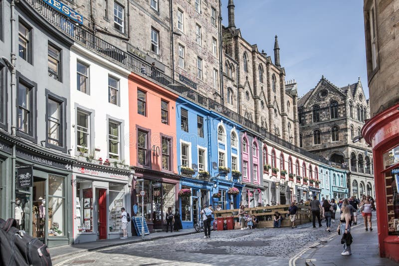 Scotland, Edinburg - August 24, 2022: Victoria street with beautiful curve and colourful shopfronts, built in 1860th and designed in the fashionable Scots Baronial style. Scotland, Edinburg - August 24, 2022: Victoria street with beautiful curve and colourful shopfronts, built in 1860th and designed in the fashionable Scots Baronial style.