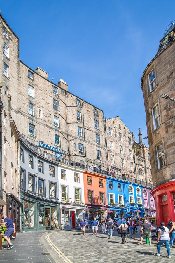 Scotland, Edinburg - August 24, 2022: Victoria street with beautiful curve and colourful shopfronts, built in 1860th and designed in the fashionable Scots Baronial style. Scotland, Edinburg - August 24, 2022: Victoria street with beautiful curve and colourful shopfronts, built in 1860th and designed in the fashionable Scots Baronial style.