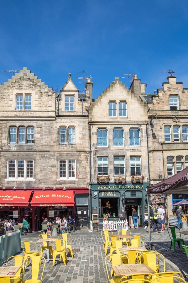 Scotland, Edinburg - August 24, 2022: Victoria street with beautiful curve and colourful shopfronts, built in 1860th and designed in the fashionable Scots Baronial style. Scotland, Edinburg - August 24, 2022: Victoria street with beautiful curve and colourful shopfronts, built in 1860th and designed in the fashionable Scots Baronial style.