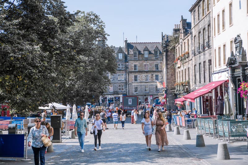 Scotland, Edinburg - August 24, 2022: Victoria street with beautiful curve and colourful shopfronts, built in 1860th and designed in the fashionable Scots Baronial style. Scotland, Edinburg - August 24, 2022: Victoria street with beautiful curve and colourful shopfronts, built in 1860th and designed in the fashionable Scots Baronial style.