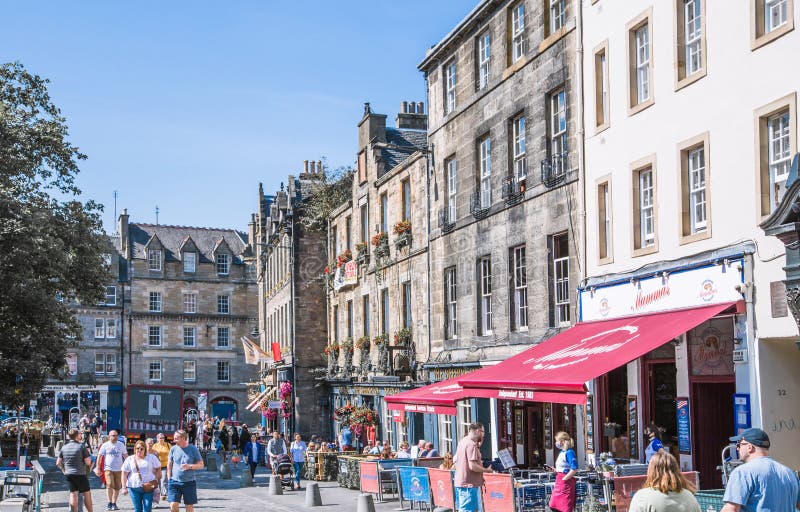 Scotland, Edinburg - August 24, 2022: Victoria street with beautiful curve and colourful shopfronts, built in 1860th and designed in the fashionable Scots Baronial style. Scotland, Edinburg - August 24, 2022: Victoria street with beautiful curve and colourful shopfronts, built in 1860th and designed in the fashionable Scots Baronial style.