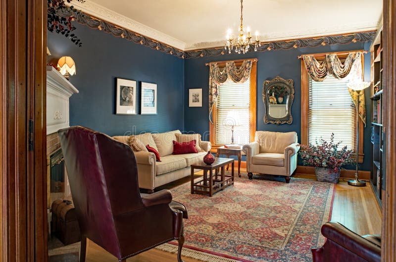 Victorian Living Room with Blue Walls. Dayton, Ohio, USA - June 10, 2018: Example of Victorian living room with navy blue walls, ten foot ceiling, crystal stock photos Victorian Living Room with Blue Walls. Dayton, Ohio, USA - June 10, 2018: Example of Victorian living room with navy blue walls, ten foot ceiling, crystal stock photos