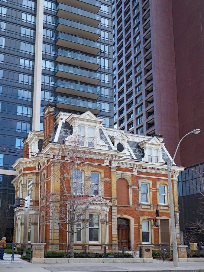 Victorian mansion nestled among modern apartment buildings in downtown Toronto. Laws to protect heritage architecture preserved this Victorian mansion nestled stock image Victorian mansion nestled among modern apartment buildings in downtown Toronto. Laws to protect heritage architecture preserved this Victorian mansion nestled stock image