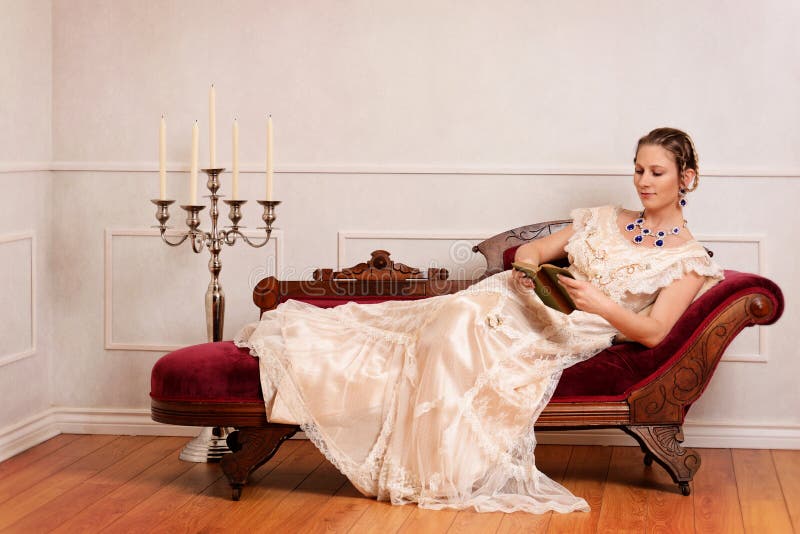 Victorian woman reading book on fainting couch royalty free stock photo Victorian woman reading book on fainting couch royalty free stock photo