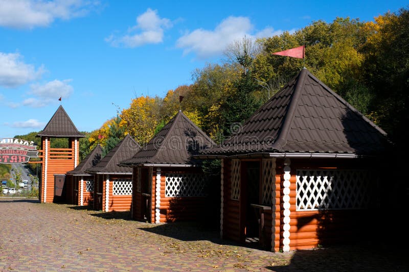 This video captures a serene relaxation area in a forested setting. Rustic hut structures are nestled among lush green royalty free stock images
