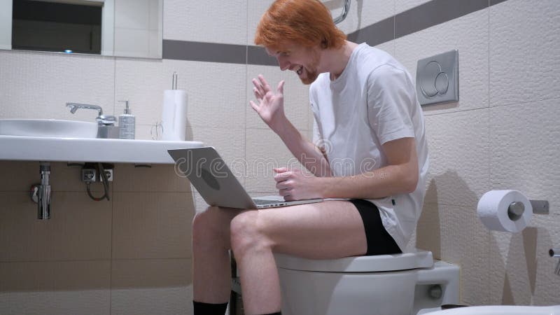 Video Chat on Laptop by Man Sitting on Toilet Commode stock images Video Chat on Laptop by Man Sitting on Toilet Commode stock images