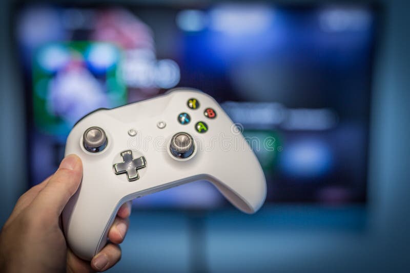 man with a controller standing in front of a PC console TV screen with a  steam controller playing popular free to play game Roblox Stock Photo -  Alamy