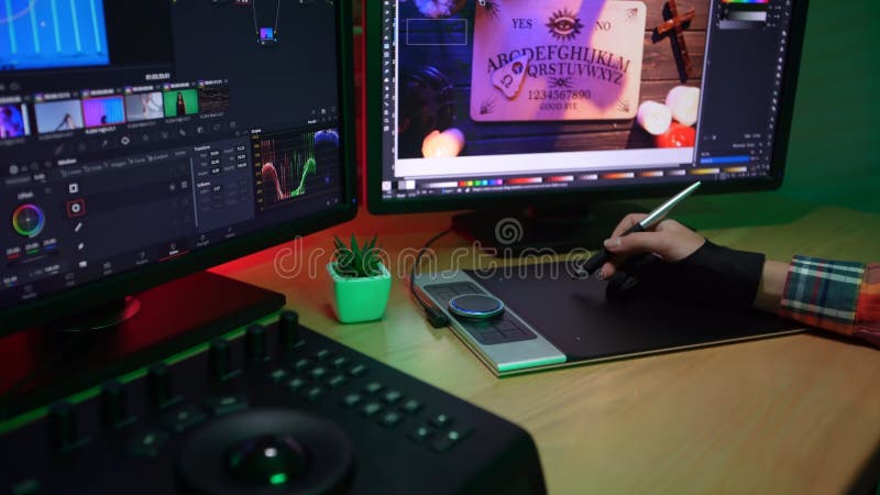 Video and photo editing advertisement concept. Freelancer working from home. Closeup shot of young female at the desk hand working on graphic tablet, monitors at the back, editing photos. Editing project stock images, royalty-free photos and pictures