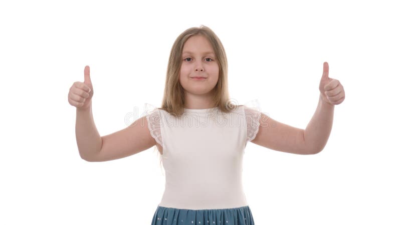 Video portrait of a pretty smiling girl holding thumbs up isolated on white background.