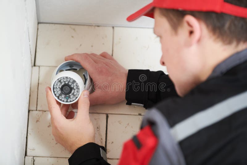 Video Surveillance Service. Technician Installing Camera Stock Image