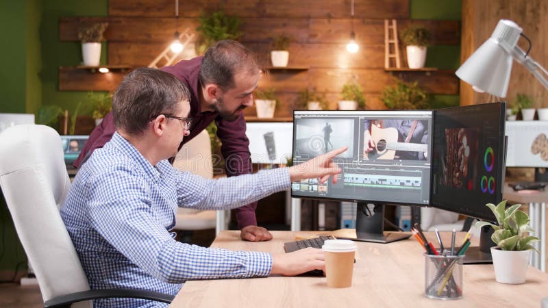 Videographer producer editing film production discussing movie graphic with photographer royalty free stock images