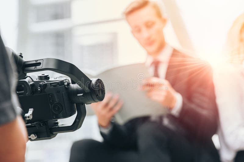 Videographer professional shooting record video usign gimbal camera stabilizer for anti shake device technology in businessman royalty free stock images