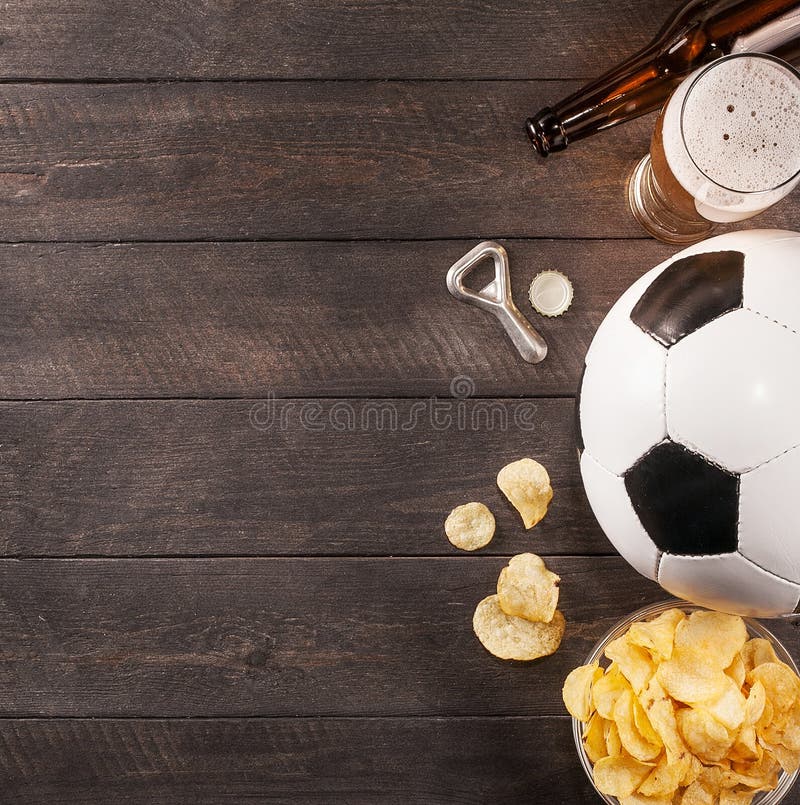 Vidrio de la cerveza y del balón de fútbol espacio de madera para el texto imagen de archivo libre de regalías Vidrio de la cerveza y del balón de fútbol espacio de madera para el texto imagen de archivo libre de regalías