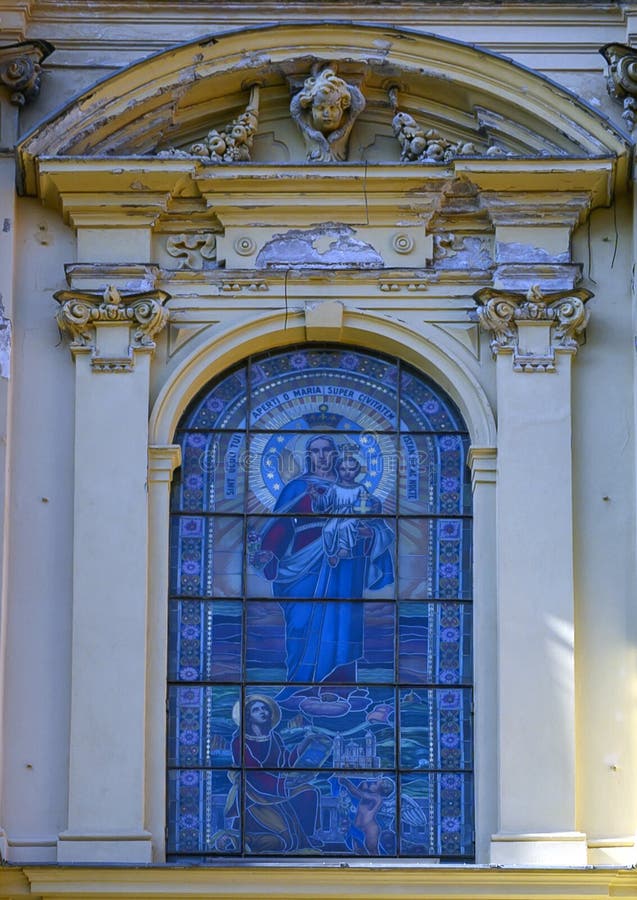 Pictured is a stained glass with the Madonna and child on the facade  of the  Basilica of Saint Margaret of Antiochia. The Basilica is now called `The Shrine of Our Lady of the Rose`.  It is a catholic place of worship located in the municipality of Santa Margherita Ligure, in Piazza Caprera, in the metropolitan city of Genoa. Pictured is a stained glass with the Madonna and child on the facade  of the  Basilica of Saint Margaret of Antiochia. The Basilica is now called `The Shrine of Our Lady of the Rose`.  It is a catholic place of worship located in the municipality of Santa Margherita Ligure, in Piazza Caprera, in the metropolitan city of Genoa.