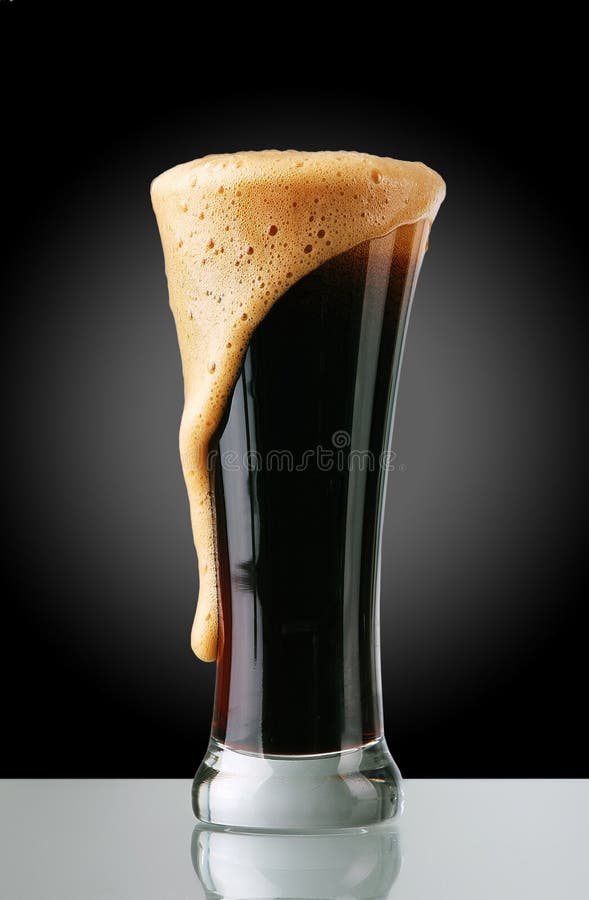 Glass of dark beer with froth. Glass of dark beer with froth