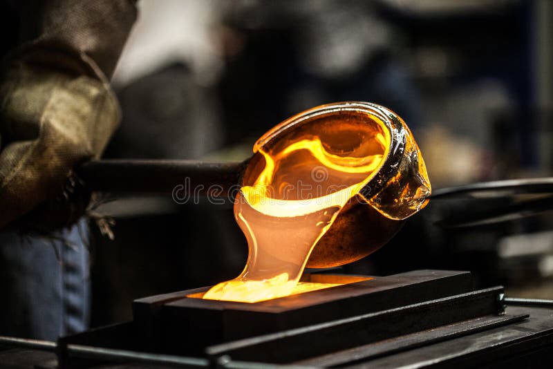 Pouring Melted Glass into Graphite Mold in Workshop. Pouring Melted Glass into Graphite Mold in Workshop