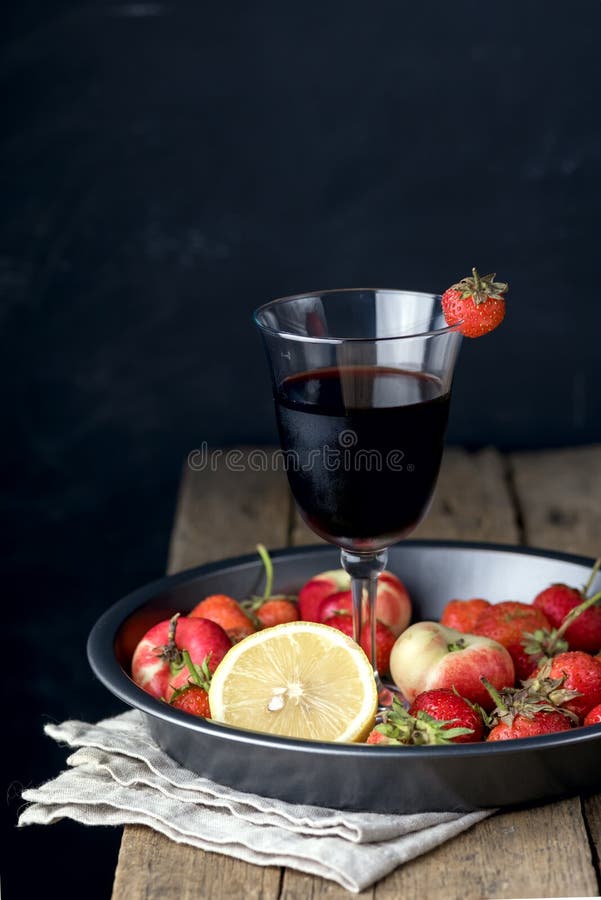 Vidro do fruto caseiro Berry Red Wine e de frutos frescos em Tray Wooden Background Vertical fotografia de stock Vidro do fruto caseiro Berry Red Wine e de frutos frescos em Tray Wooden Background Vertical fotografia de stock