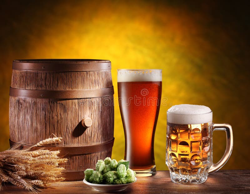 Beer glasses with a wooden barrel. Background - dark yellow gradient. Beer glasses with a wooden barrel. Background - dark yellow gradient.