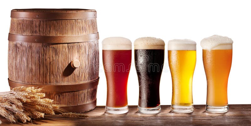 Assortment of beer glasses with a wooden barrel on a white background. Assortment of beer glasses with a wooden barrel on a white background.