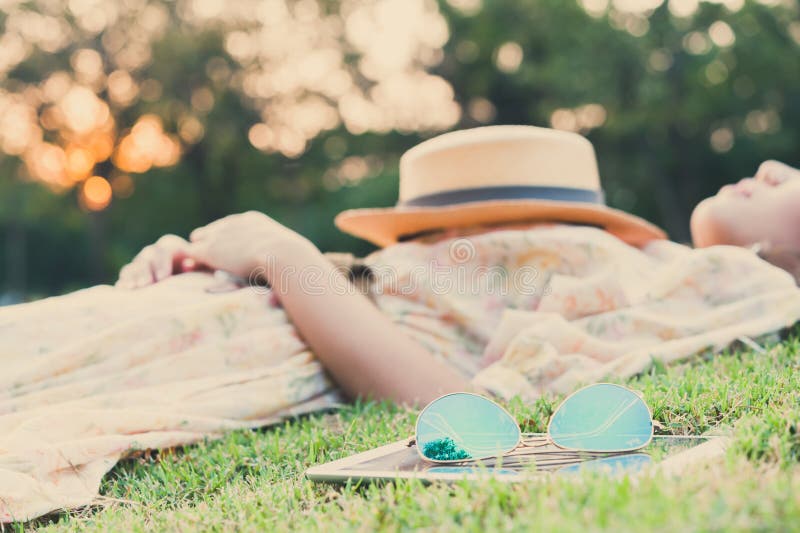 Fasion sun glasses with young woman sleeping in background, vintage style. Fasion sun glasses with young woman sleeping in background, vintage style