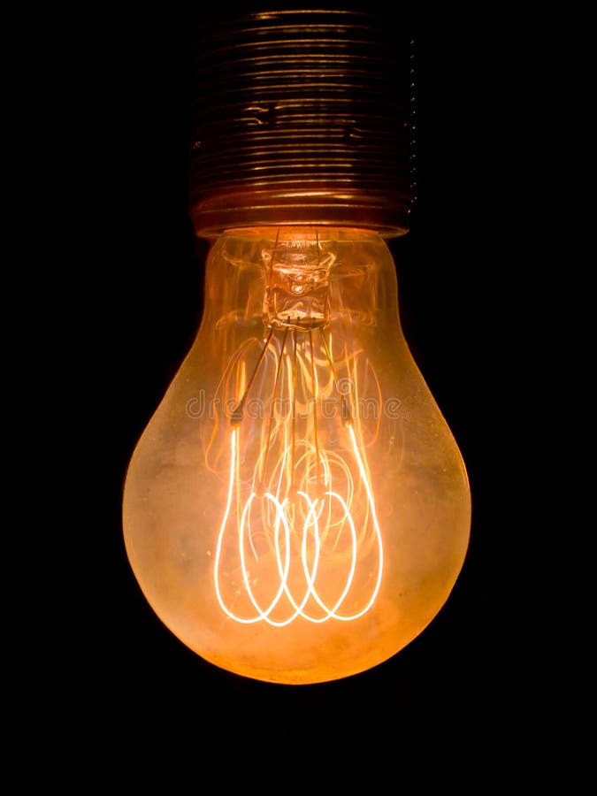 Old dusty light bulb glowing in the dark. Old dusty light bulb glowing in the dark