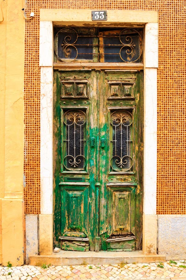 Old, wooden, green door in Portugal. Old, wooden, green door in Portugal.