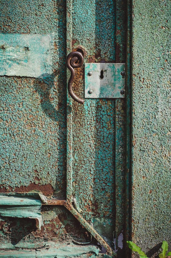 An old wood door with cracked red paint and grunge. An old wood door with cracked red paint and grunge