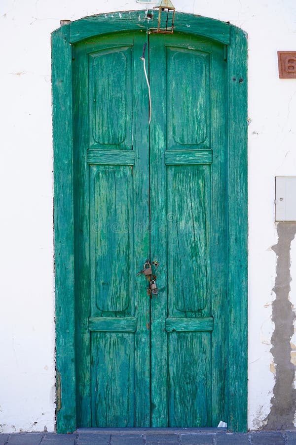 Unique green old door of a white house. Unique green old door of a white house