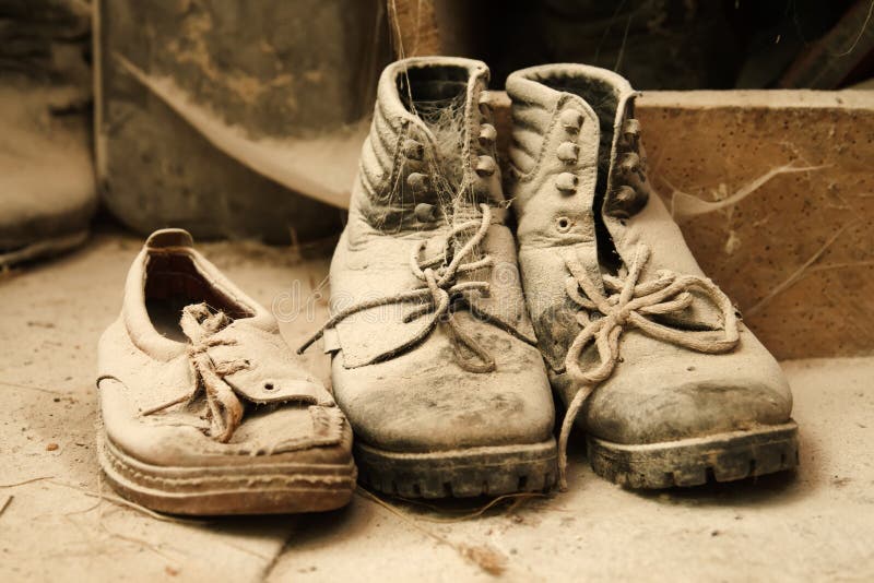 Old dusty shoes in the attic of a mill. Old dusty shoes in the attic of a mill