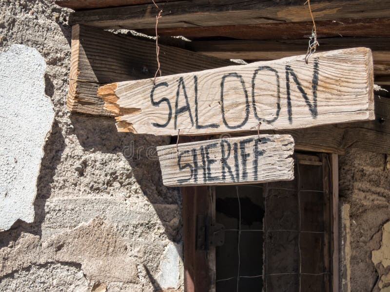 Saloon and Sheriff office sign in old western mining town. Saloon and Sheriff office sign in old western mining town