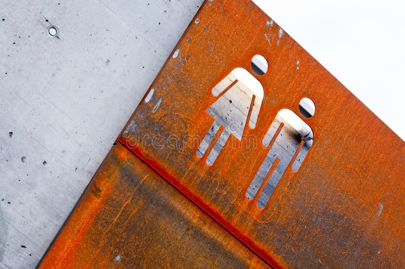 Vieja muestra oxidada del metal del hombre y de la mujer imagen de archivo libre de regalías Vieja muestra oxidada del metal del hombre y de la mujer imagen de archivo libre de regalías