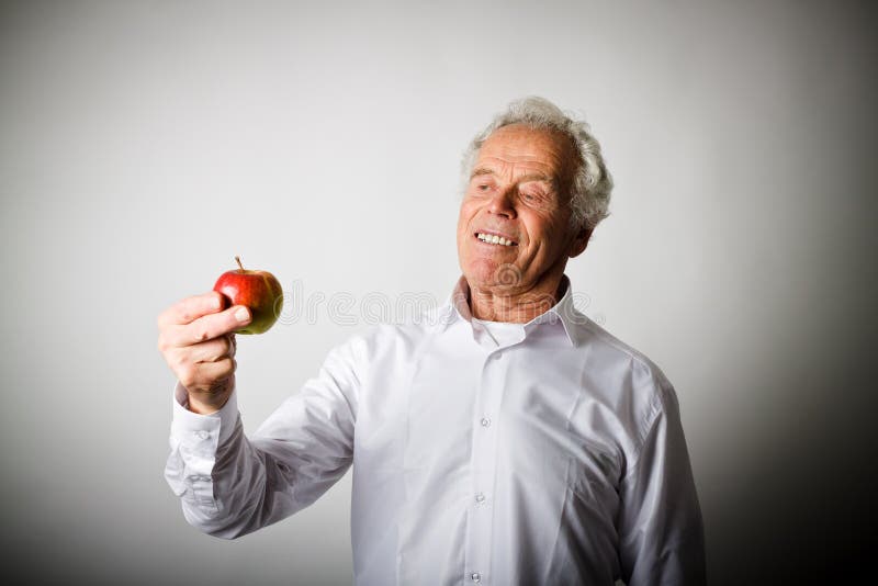Viejo hombre en blanco y manzana fotos de archivo Viejo hombre en blanco y manzana fotos de archivo