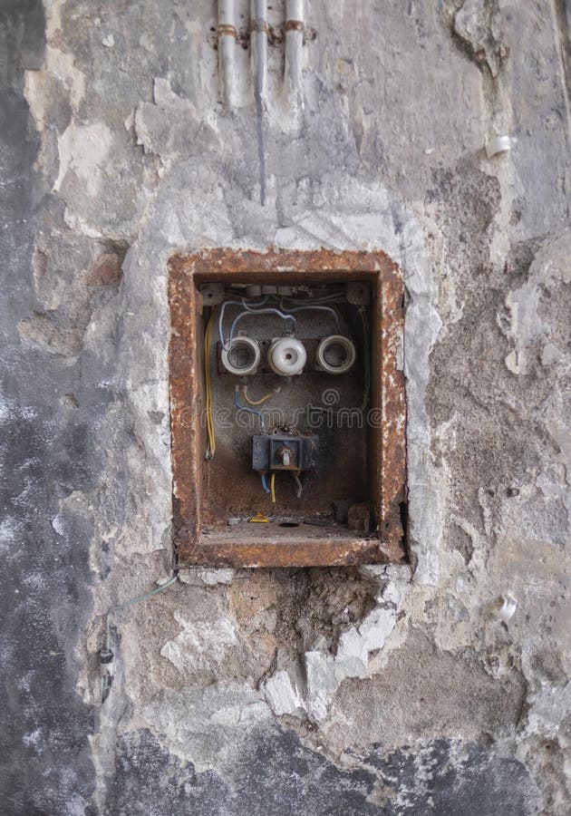 Viejo mún Rusty Switch Box en la pared resistida foto de archivo Viejo mún Rusty Switch Box en la pared resistida foto de archivo