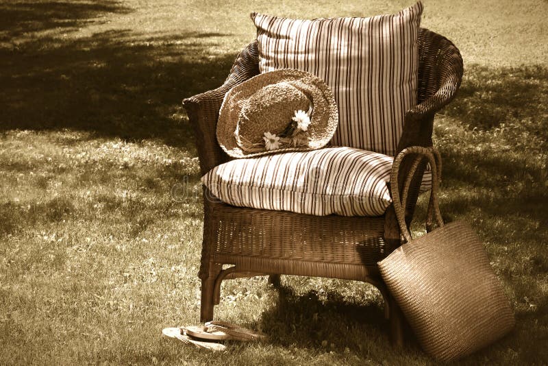 Wicker chair and old summer hat on a hot summer's day. Wicker chair and old summer hat on a hot summer's day