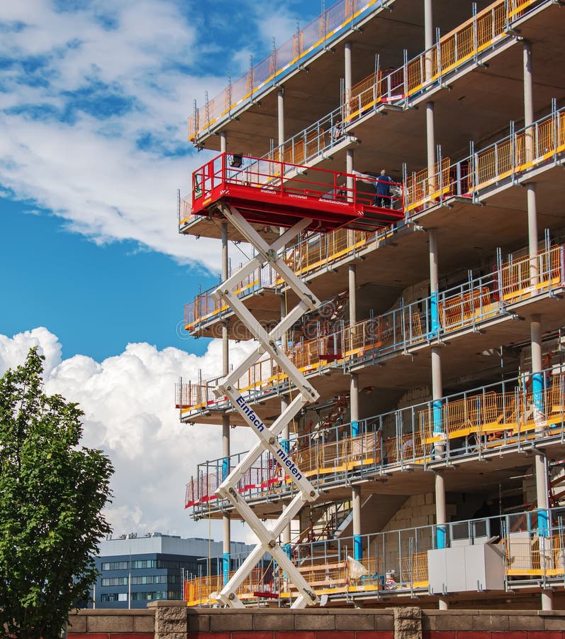 Crane and construction site against blue sky