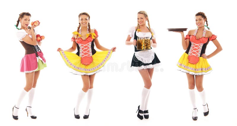 Vier junge bayerische Mädchen, die in den reizvollen Kleidern aufwerfen lizenzfreie stockbilder Vier junge bayerische Mädchen, die in den reizvollen Kleidern aufwerfen lizenzfreie stockbilder