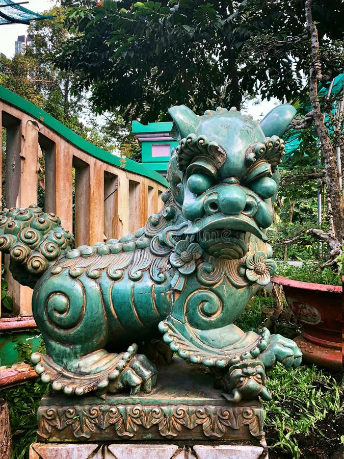 Vietnamese lion statue made of green glazed ceramics against a green garden royalty free stock photography Vietnamese lion statue made of green glazed ceramics against a green garden royalty free stock photography