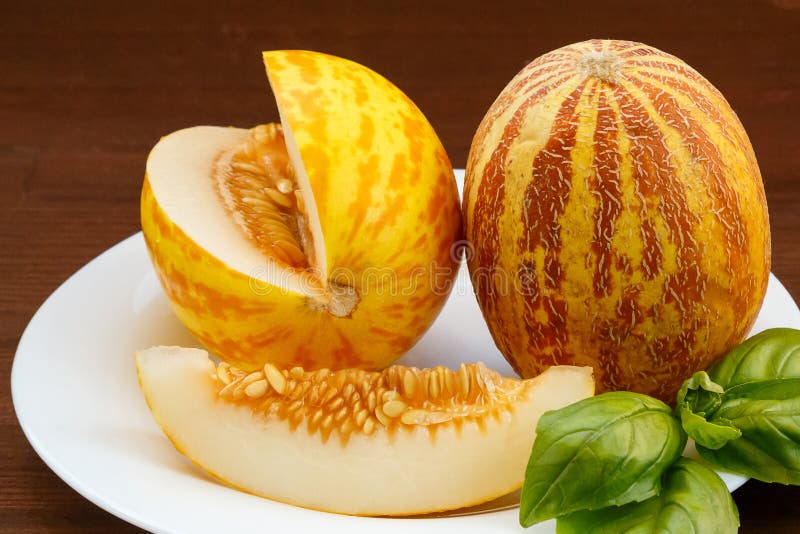 Vietnamese Melon, Lime, Figs, Orange, Kiwi and Juice are on a White