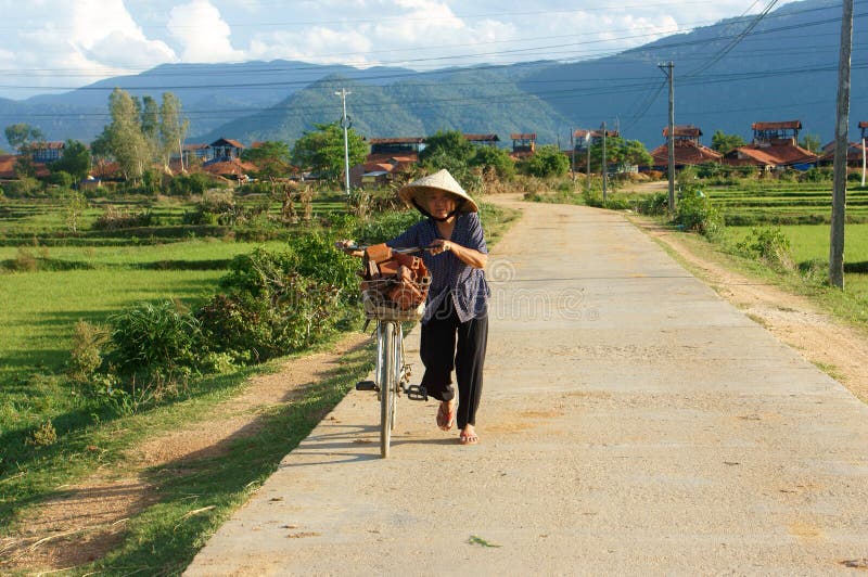 Vietnamese old woman ride bicycle royalty free stock photos Vietnamese old woman ride bicycle royalty free stock photos