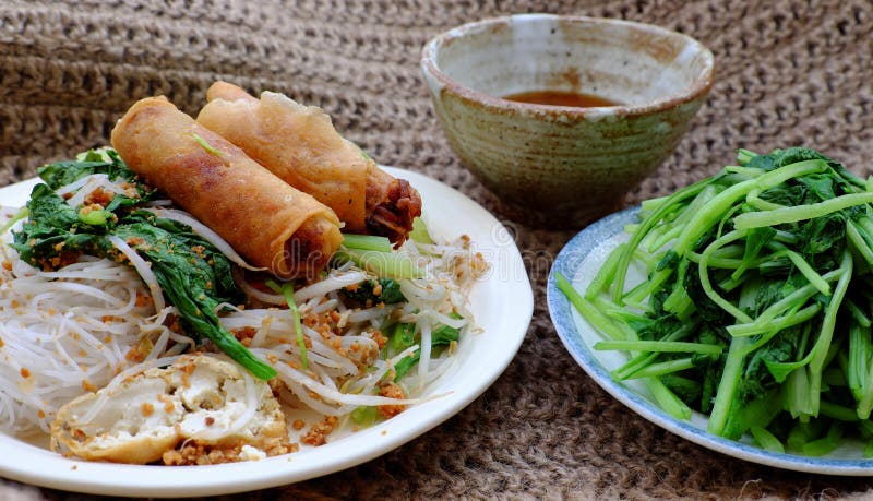 Vietnamese vegetarian food for breakfast, rice noodle with fried spring roll, vegetables for vegan meal stock photos Vietnamese vegetarian food for breakfast, rice noodle with fried spring roll, vegetables for vegan meal stock photos