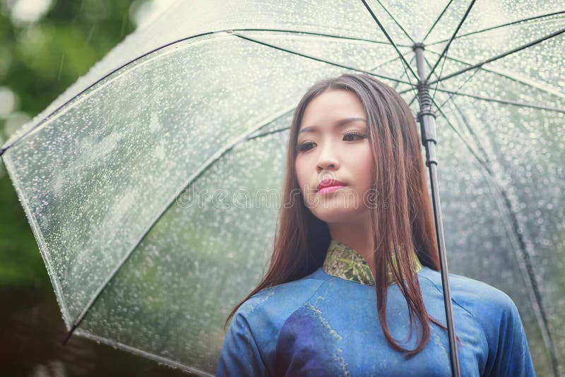 Vietnamese Women Wear Ao Dai In The Rain Stock Image 