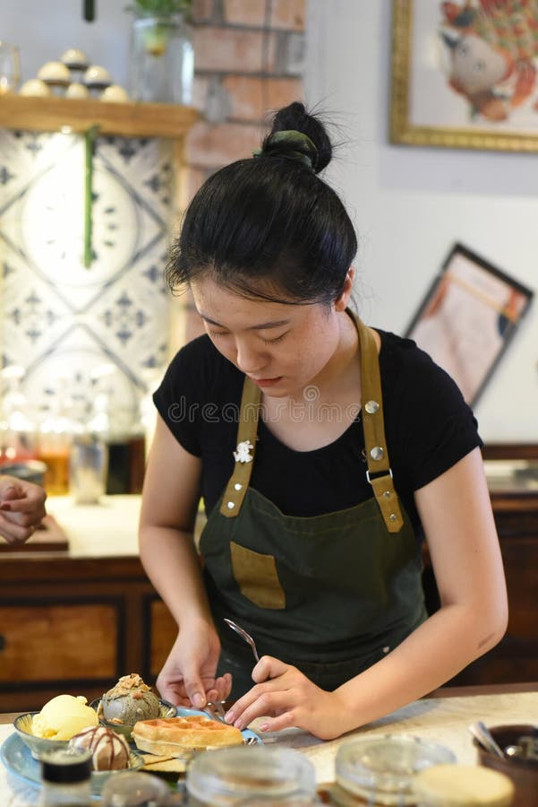 Vietnamese Young Waitress Preparing Home Made Ice Cream for a C photo