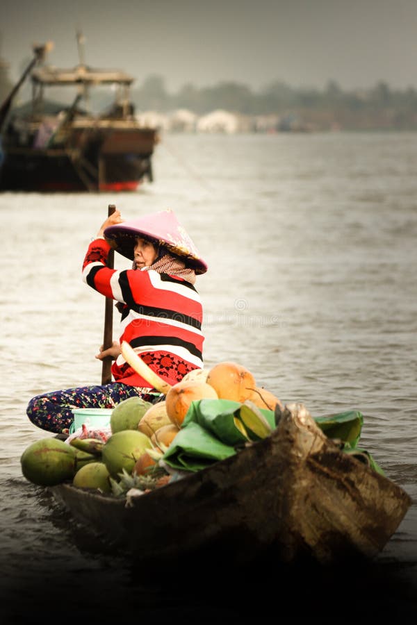 Vietnamse coconut seller at the floating market royalty free stock image