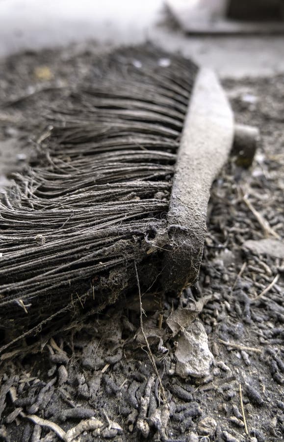 Detail of old and damaged broom for sweeping dirt. Detail of old and damaged broom for sweeping dirt