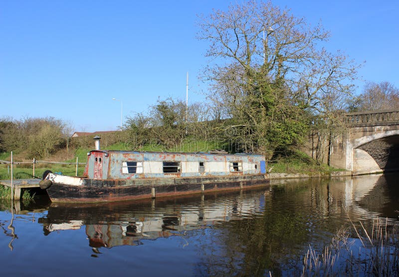 Old canal narrow boat moored at the side of the Lancaster canal on the outskirts of Garstang in Lancashire. Old canal narrow boat moored at the side of the Lancaster canal on the outskirts of Garstang in Lancashire.