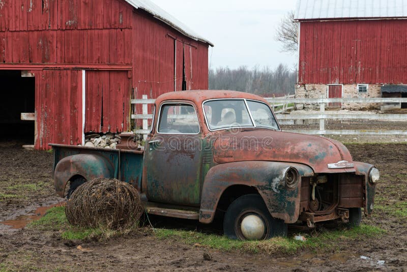 An old classic rusty pickup truck sits on a Wisconsin dairy farm. An old classic rusty pickup truck sits on a Wisconsin dairy farm.